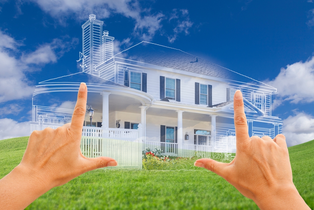 Female,hands,framing,beautiful,custom,house,drawing,and,ghosted,house